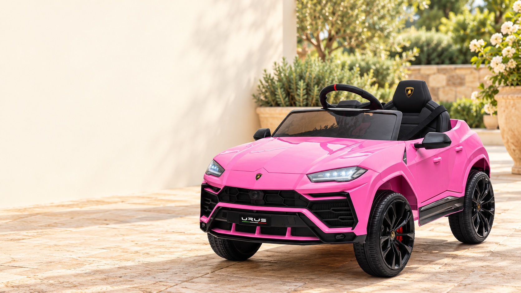 Pink electric ride-on toy with black wheels and an open seatslider_item_1